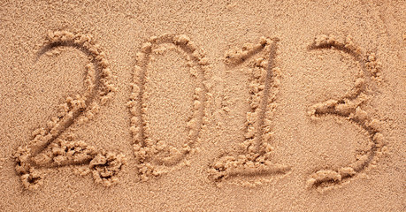 Happy New Year 2013 on the sea beach with the sun rays