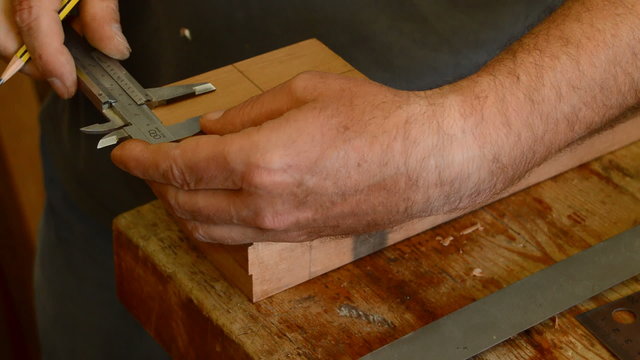 Luthier in fabrication of a guitar mastil, close up