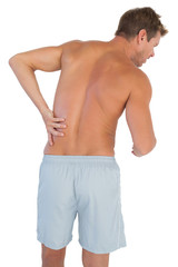 Man with shorts suffering from lower back pain