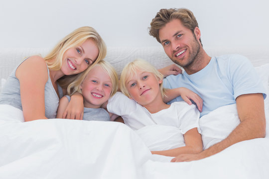 Portrait of a family in bed