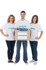 Obraz premium Group of volunteers holding donation box with clothes
