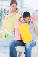 Angry man while his girlfriend is shopping