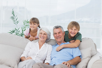 Grandchildren and grandparents sitting on couch