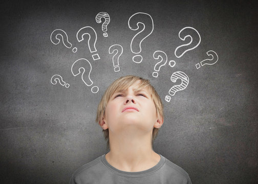 Thinking child looking at question marks