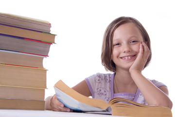 Smiling girl with pile of books