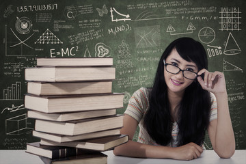 Beautiful female nerd student study in class