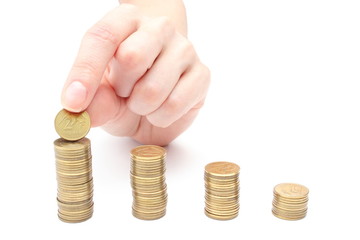 Hand put coins to stack of coins