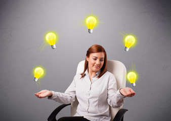 young lady sitting and juggling with light bulbs