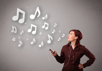 Pretty young woman singing and listening to music with musical n