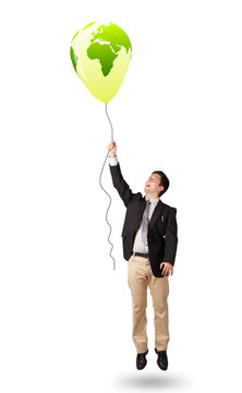 handsome man holding a green globe balloon