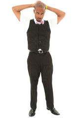 Attractive young black man in suit with bow tie, hands on head.