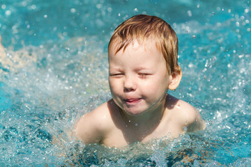 Fototapeta na wymiar Three years old boy in swimming pool