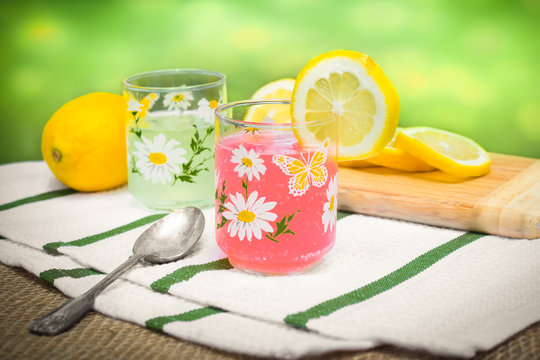 Arrangement of pink lemonade and lemons outside