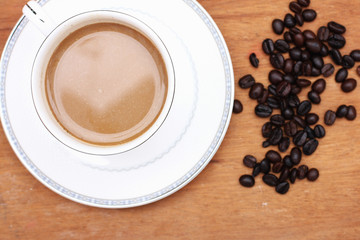 Coffee beans with coffee. wood background
