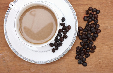 Coffee beans with coffee. wood background