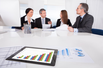Digital Tablet In Front Of Businesspeople