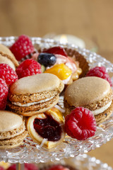Parisian macarons, raspberries and other delicacy. Closeup