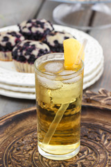 Peach drink. Apricot pie on cake stand in the background