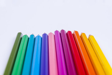 Colourful crayons on white background.