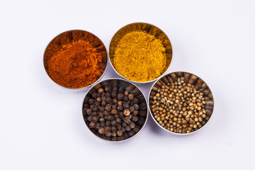 Curry, pepper,  paprika and coriander - white background.