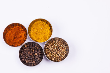 Curry, pepper,  paprika and coriander - white background.