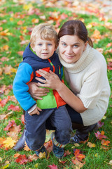 Little toddler boy and young mother in the autumn park © Irina Schmidt