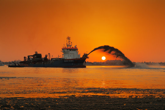 A dredging ship in action at Palm Jumeirah, Dubai, UAE