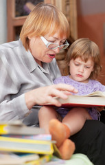 grandmother and child reads  book