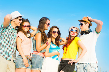 group of young people wearing sunglasses and hat