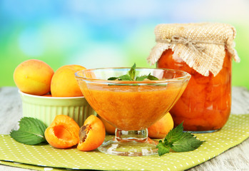 Apricot jam in glass jar and fresh apricots,