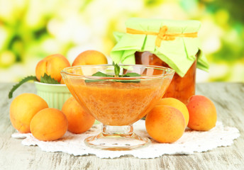 Fototapeta na wymiar Apricot jam in glass jar and fresh apricots,