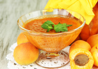 Apricot jam in glass jar and fresh apricots,