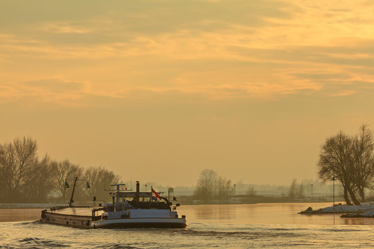 Riverboat during winter on the river IJssel in The Netherlands