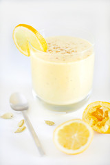 Fruit juice smoothie or milkshake with lemon and cardamom