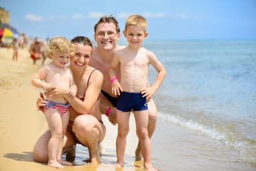 Happy caucasian family at ocean beach