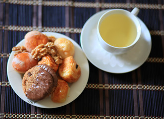 Сookies, nuts, pastries and a cup of green tea