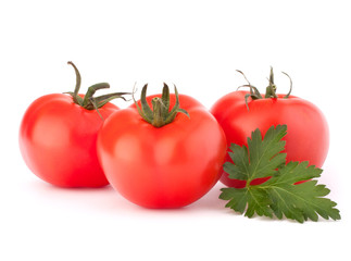 Three tomato vegetables and parsley leaves still life
