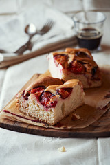 Homemade plum cake on wooden kitchen board