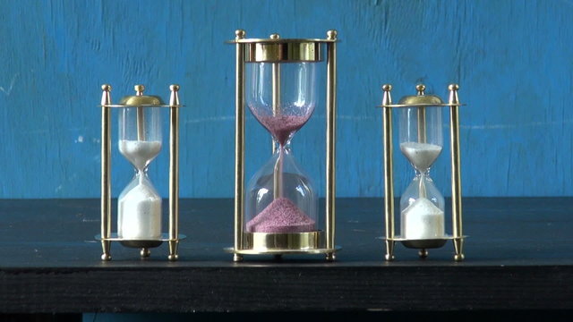 three sand glass, hourglass  and sand flow motion