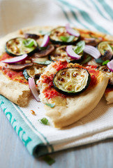 Pizza with grilled zucchini, onion, mushrooms and pine nuts