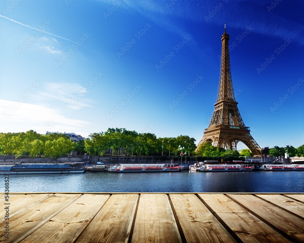 Aufkleber background with wooden deck table and eiffel tower in paris