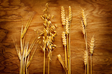 Different types of cereals on old wood background