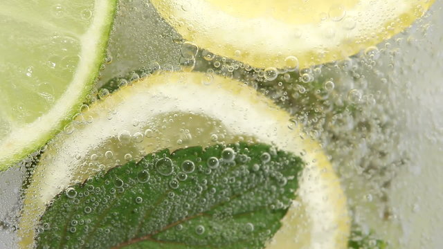 Macro shot of pouring lemonade in glass.