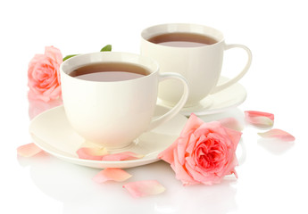 cups of tea with roses isolated on white