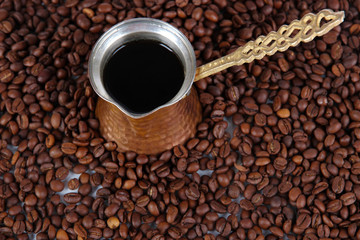 Coffee pot on coffee beans background