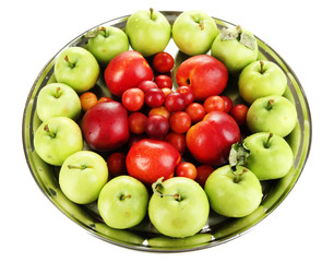 Assortment of juicy fruits on plate, isolated on white