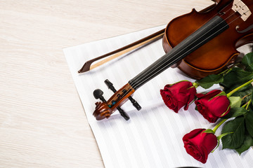 Fototapeta premium Violin, rose and music books