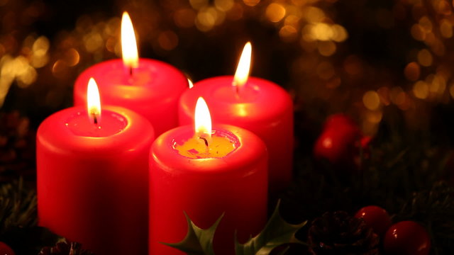 Close up of four burning candles