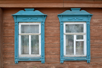 Two windows with blue carved platbands