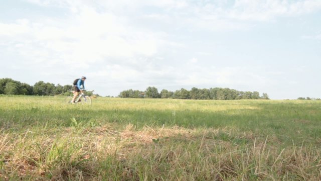 cyclist riding a MTB on green grass